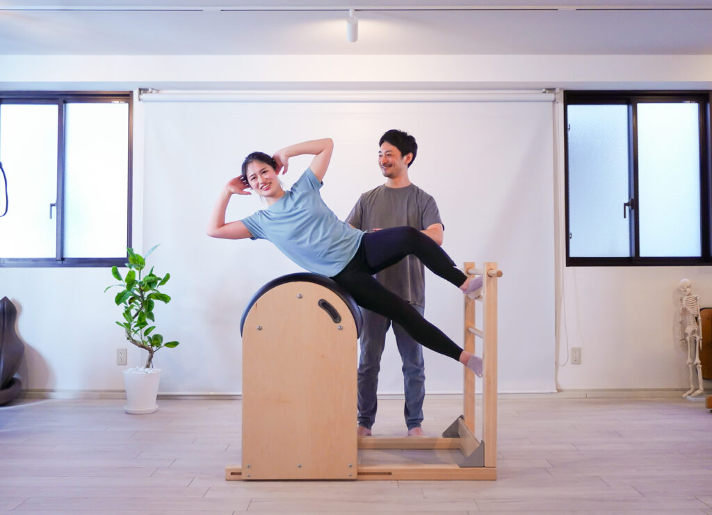 ピラティスのラダーバレル(Balanced Body)を使ったサイドシットアップエクササイズの様子