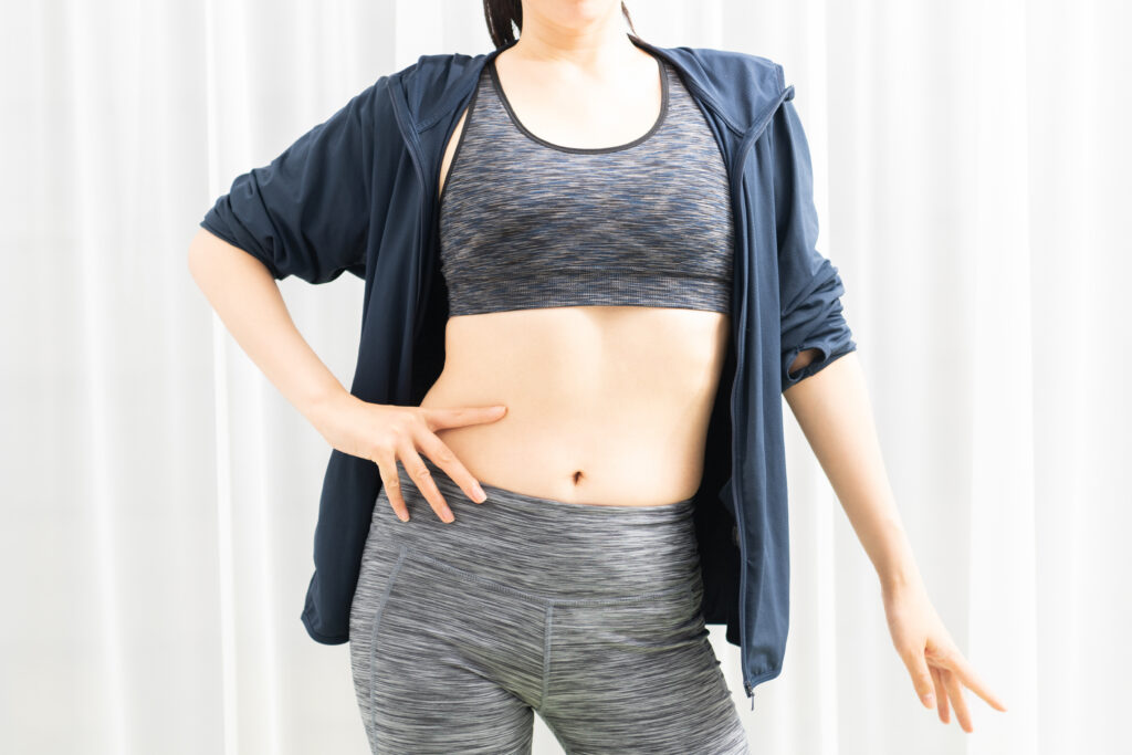 ウォールピラティスで体幹を鍛え、引き締まったお腹と美しい姿勢を目指す女性のポーズ。